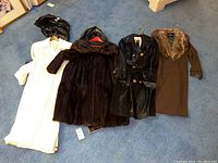 All four coats laid out on blue carpet