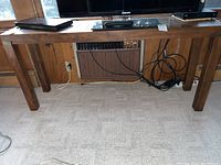 Full view of Drexel Heritage wooden console table with tapered legs and various electronics on top. Shows overall dimensions and table profile.