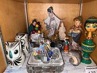 Shelf view showing entire grouping of porcelain, ceramic, crystal and stone pieces