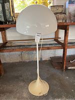 Full front view showing cream tulip base and white dome shade