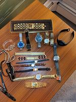 Overhead shot showing assortment of wristwatches and bands