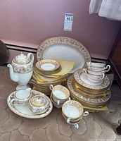 Full view of dinnerware and tea service on carpet