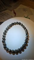 Front photo of the yooperlite stretchy bracelet showing the natural gray beads with dark specks arranged in a circle.