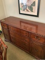 Front view of solid wood buffet with multiple drawers and cabinets, showing overall design and condition.