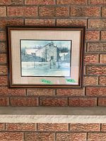 Framed rustic scene artwork on a brick wall with size label 84x66