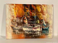 Full view of the oil painting showing boats docked by piers and buildings, highlighting colors and artist signature.