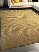 Full view of rug laid on floor in front of sectional sofa