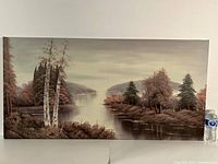 Full view of the large rectangular oil painting on canvas showing a river landscape with trees and hills, with a water bottle for scale.