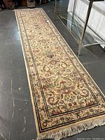 Full view of long narrow runner showing overall pattern and fringed ends