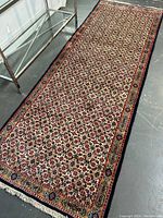 Full view of the carpet laid on a gray floor showing overall pattern and shape, verifying size and condition.
