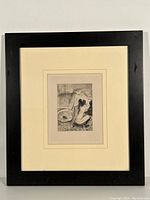 Full front view of framed lithograph showing black frame, cream mat, and print.