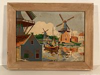 Full view of the oil painting in a simple wooden frame showing Dutch windmills, boats, and buildings by the water.