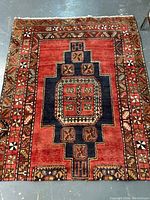 Full view of the red and blue central medallion Meshkin Persian carpet