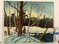 Wide view of the signed oil painting showing birch trees in foreground with snow, distant dark green trees, blue sky, and mountains.