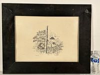 Framed ink drawing of a beaver in natural setting with water and vegetation, scale shown by water bottle.