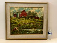 Full view of the framed oil painting depicting red barns with cows grazing in a green field near a pond.