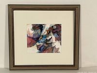 Full view of the framed abstract watercolour painting hung on a white wall, showing composition and framing.