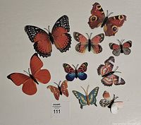 Top view of the 10 butterfly fridge magnets arranged on a white surface, showing variety in color and design.