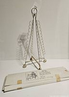 Front view of the metal card display tree standing upright showing triangular shape and wire loops on each side.