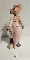 Front view of Emilio Casarotto Pink Lady sculpture with dog figurine, showing full figure, outfit details, and accessories.