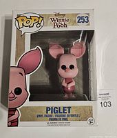 Front view of the boxed Funko Pop Piglet vinyl figure from Disney Winnie the Pooh series number 253, showing figure and packaging graphics.