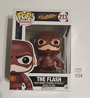 Front view of The Flash Funko Pop! figure in original packaging, showing item number 213 and box graphics