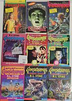 Nine used paperback horror books spread out on a surface, including Goosebumps titles by R.L. Stine, two Fright Time volumes, and Are You Afraid of the Dark: The Tale of the Restless House.