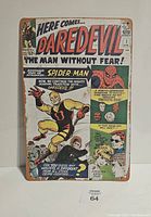 Front view of the Marvel Comics Daredevil tin sign showing colorful Daredevil and Spider-Man comic art with text.