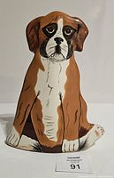 Front view of the dog-shaped ceramic vase showing the detailed facial features and brown and white coloring.
