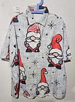 Front view of XL short-sleeve button-up shirt with retro Santa gnome print hanging on hanger.
