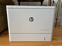 Front and right side view of the HP LaserJet printer showing HP logo and model label.