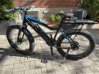 Left-side profile of bike showing frame, battery pack, fork and front tire