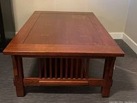 Side view of oak coffee table showing sturdy legs and craftsmanship details.