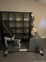 Left side view of the Frequency 500R recumbent bike showing mesh backrest, padded seat, frame, and console.