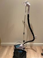 Full view of TOBI clothes steamer with the clothing stand and hose, showing overall condition.