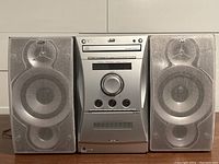 Front view of JVC FS-L30 stereo system with two attached speakers with mesh covers.