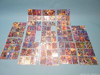 Full view of almost all Marvel trading cards arranged on a surface, showing colorful imagery and many character depictions.