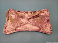 Full top-down view of the pink ceramic rectangular divided dish showing three compartments and abstract mist pattern.