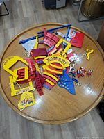 Disassembled Playmobil Romani Circus set pieces spread on table showing circus seating, ramps, signage, and other parts.