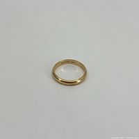 Ring laid flat showing overall appearance and interior hallmark