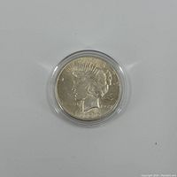 Obverse side of 1925 Peace Silver Dollar featuring Lady Liberty profile and year 1925.