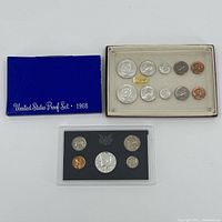 Photo shows three proof sets: a 1968 set in a blue embossed envelope, a 1959 proof set in a clear plastic case with black background, and a 1963 proof set in a clear plastic case with white velvet background containing coins arranged in two rows.