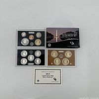 Complete set with three plastic holders containing coins, box, and certificate of authenticity.