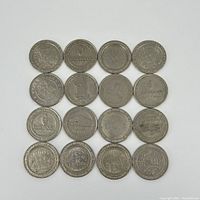 Top down view of all 16 metal gaming coins arranged in a 4x4 grid showing various casino logos and designs.