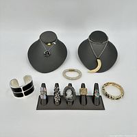 Group display of all costume jewelry items together, showing variety of rings, bracelets, and necklaces