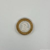 Top-down close view of the front side of the coin showing Babe Ruth portrait and inscriptions within the Plexi case.