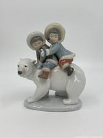 Front view of Lladro figurine showing two children on a polar bear.