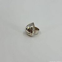 Front and side view of the domed sterling silver ring showing smooth polished surface and shape.