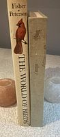 Spine and side view of two large books: The World of Birds and Artist: Birds 1973