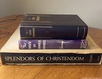 Three Christian books stacked: 'Splendors of Christendom,' 'The Great Controversy,' and 'The Voice of Israel's Prophets' showing different sizes and covers